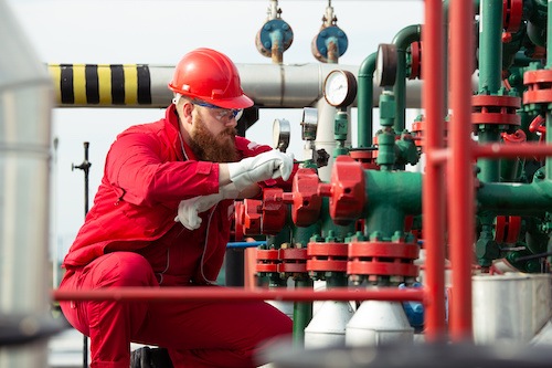 A refinery worker that is utilizing well monitoring solutions