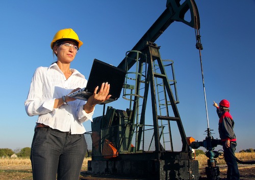 An oil and gas engineer using automated well monitoring systems